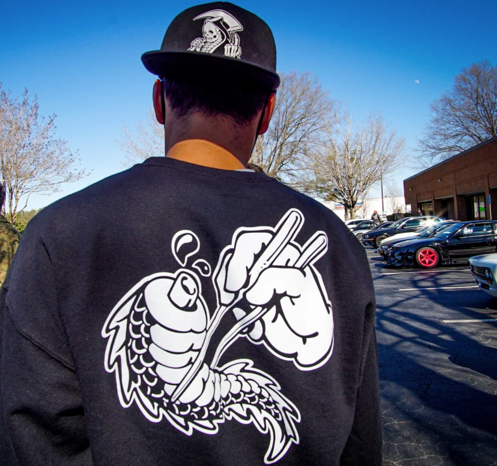 Unisex cotton black crewneck sweatshirt with tōge (roadway) chest emblem on front in white ink and conquering the tail of the dragon design in white on back. And reaper snapback hat