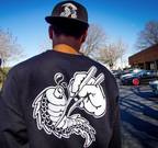 Unisex cotton black crewneck sweatshirt with tōge (roadway) chest emblem on front in white ink and conquering the tail of the dragon design in white on back. And reaper snapback hat